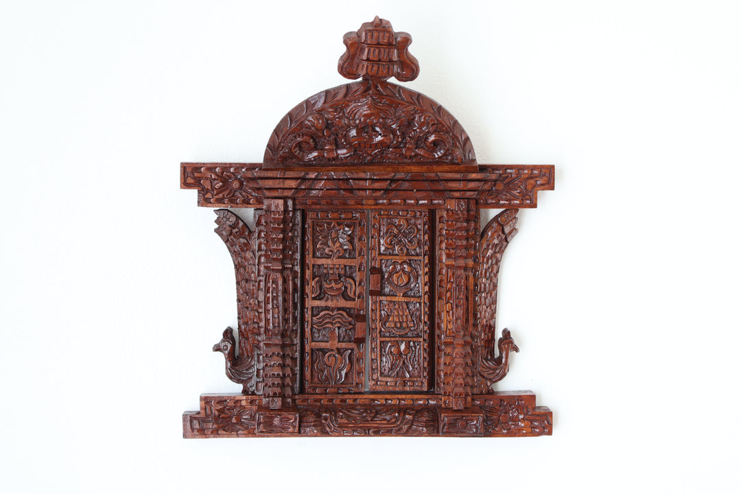 Handcrafted Nepalese wooden frame with Asta Mangal symbols, perfect for spiritual home décor and bohemian wall art.