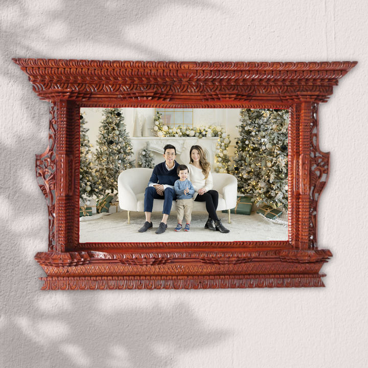 Handcrafted wooden photo frame displaying a family portrait, blending Nepalese craftsmanship with modern elegance.