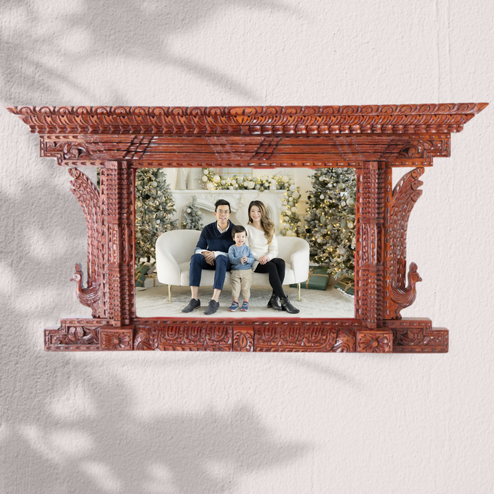 Handcrafted wooden photo frame displaying a family portrait, blending Nepalese craftsmanship with modern elegance.