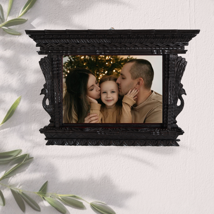 Handcrafted wooden photo frame displaying a family portrait, blending Nepalese craftsmanship with modern elegance.